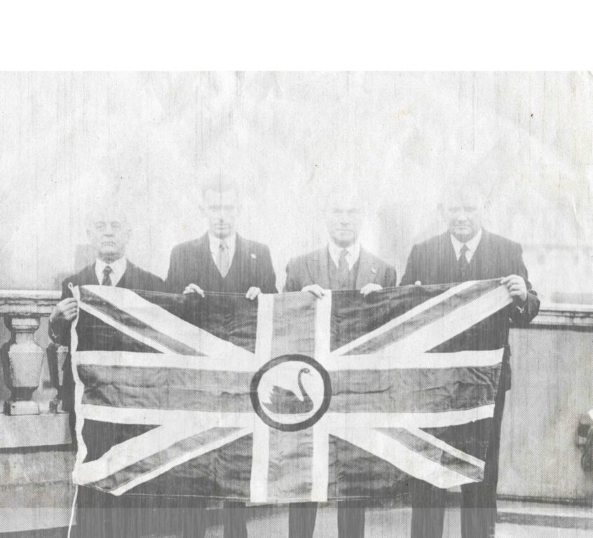 MEMBERS OF WA'S DOMINION LEAGUE MATTHEW LEWIS MOSS, H K KEITH WATSON, JAMES MACCALLUM SMITH MLA AND SIR HAL COLEBATCH FLY THE FLAG IN LONDON.